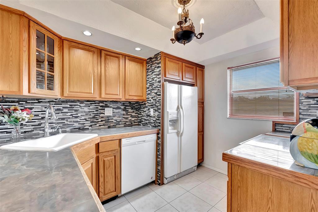 8380 Sands Point Boulevard, Unit J306 Tamarac, FL 33321 - Photo 26 of 33 a kitchen with stainless steel appliances granite countertop a sink and a refrigerator