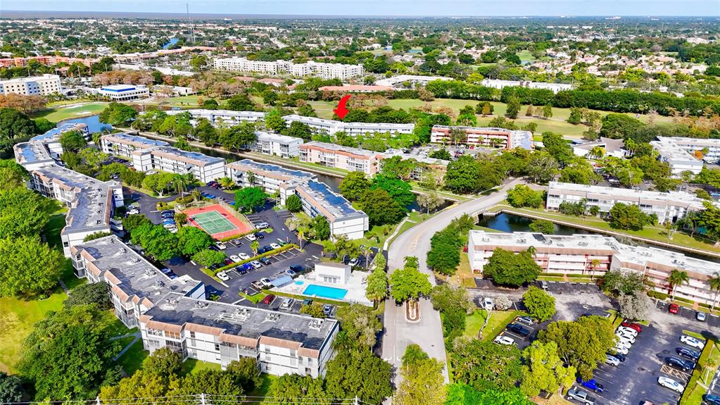 8380 Sands Point Boulevard, Unit J306 Tamarac, FL 33321 - Photo 8 of 33 an aerial view of residential houses with outdoor space and swimming pool