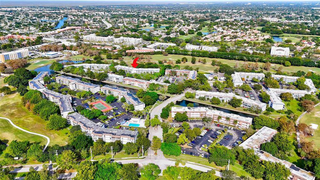 8380 Sands Point Boulevard, Unit J306 Tamarac, FL 33321 - Photo 9 of 33 an aerial view of residential houses with outdoor space