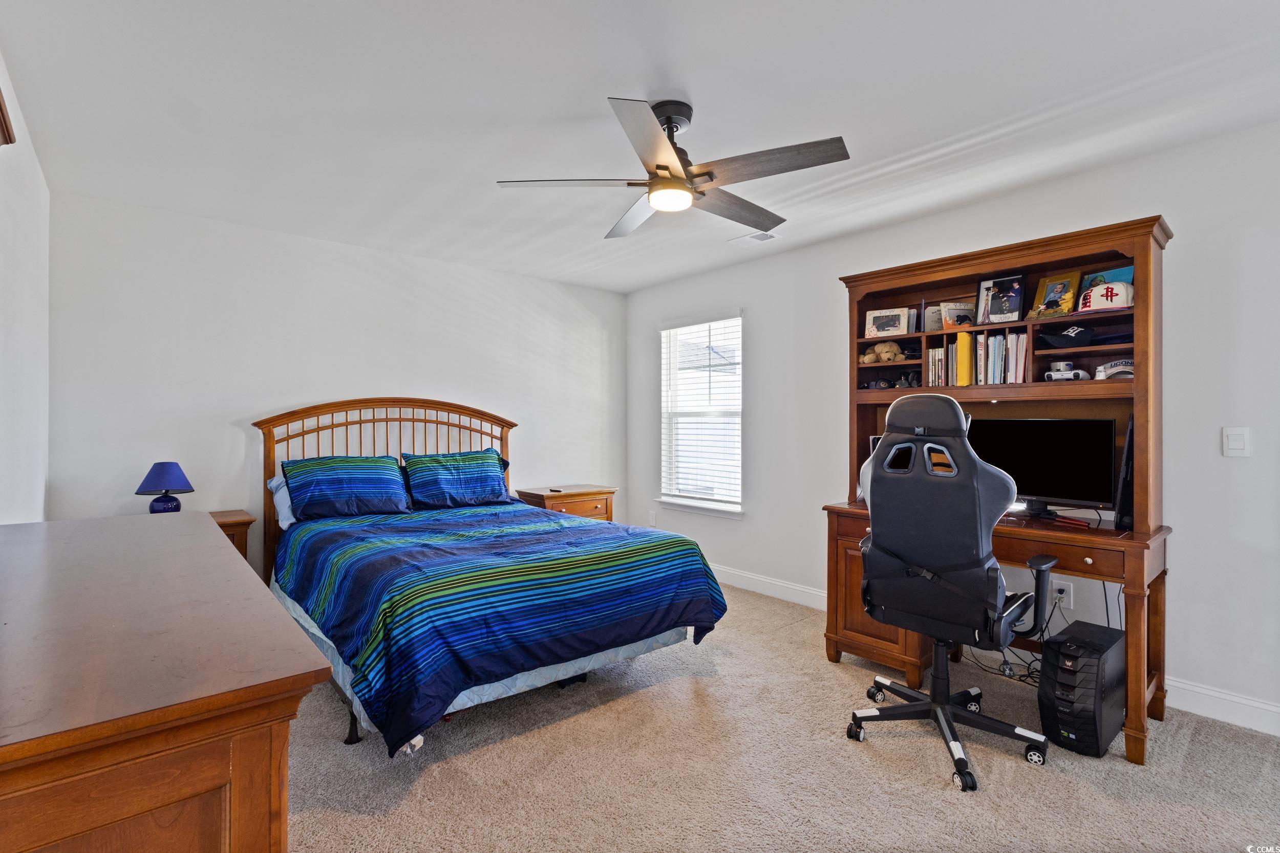 4070 Rutherford Court Little River, SC 29566 - Photo 20 of 40 Bedroom featuring light carpet, a ceiling fan, and a desk