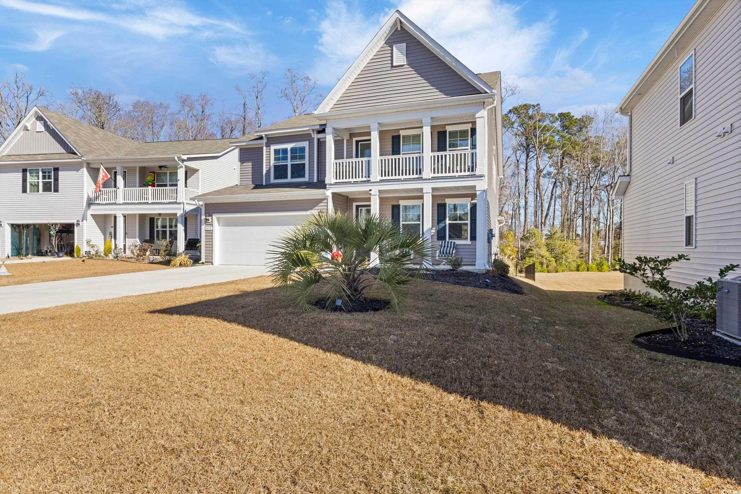 4070 Rutherford Court Little River, SC 29566 - Photo 2 of 40 View of front of home featuring driveway, a front yard, a porch, and an attached garage
