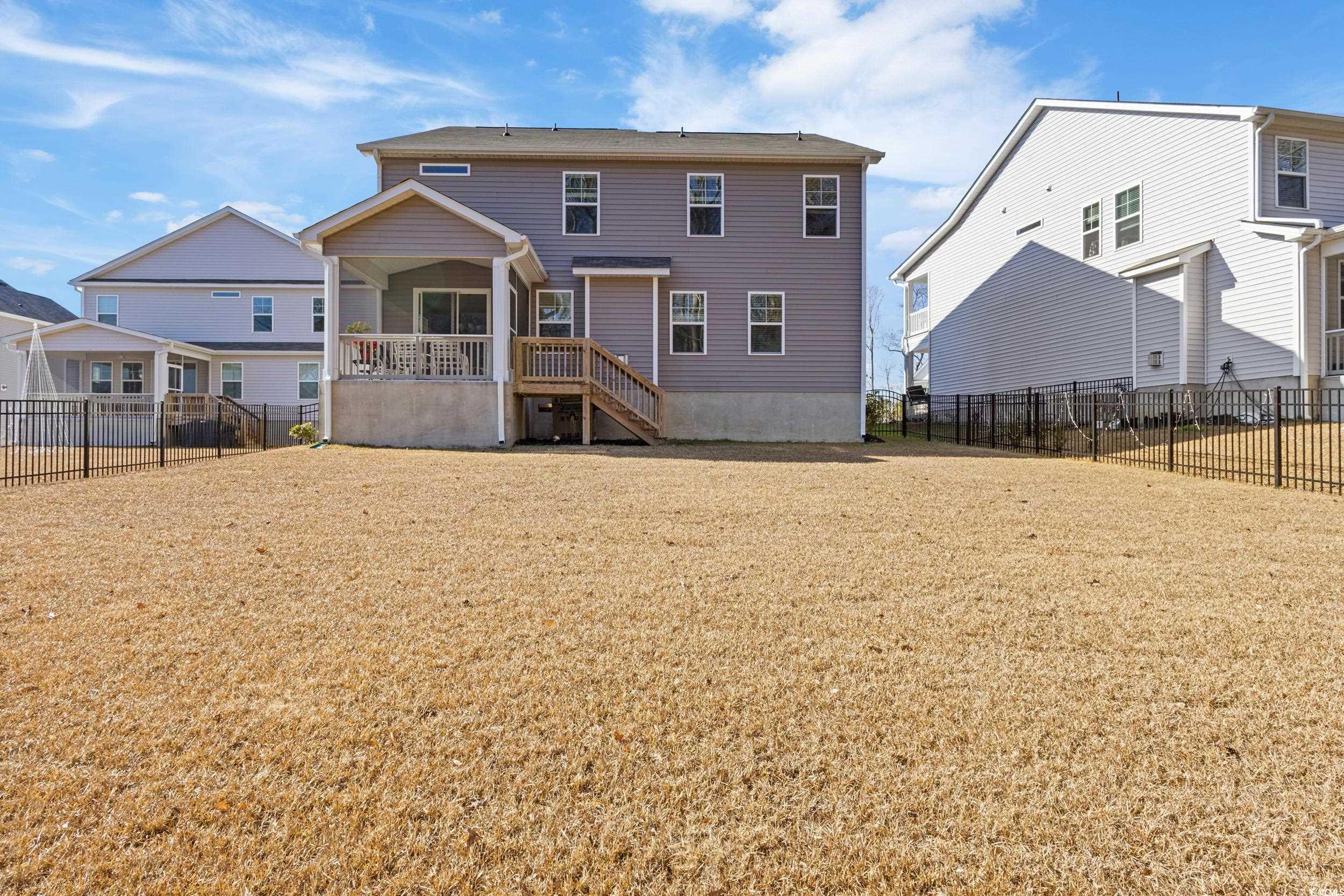 4070 Rutherford Court Little River, SC 29566 - Photo 3 of 40 Back of property with a fenced backyard and stairway