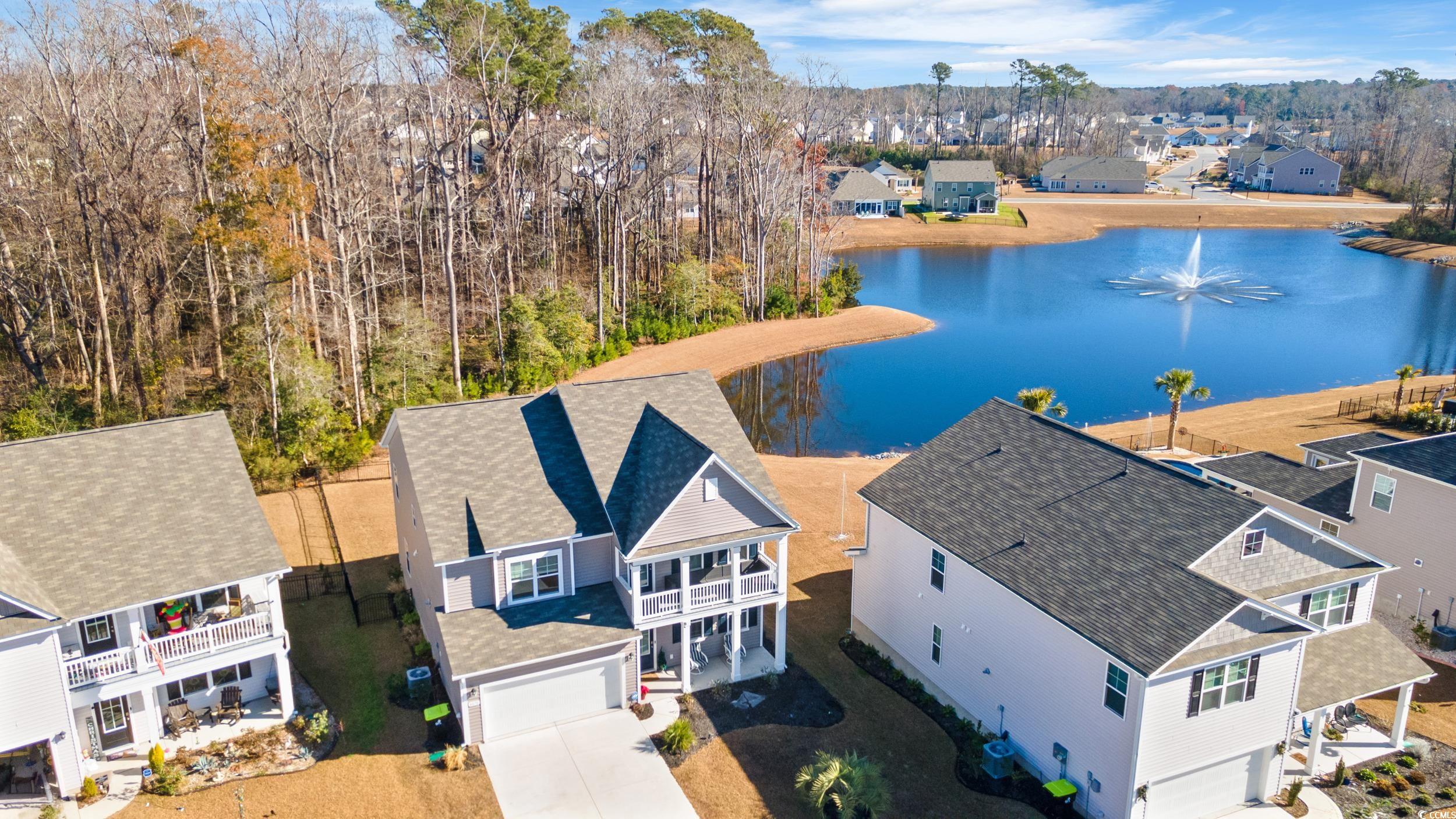 4070 Rutherford Court Little River, SC 29566 - Photo 4 of 40 Aerial perspective of suburban area with a large body of water and a tree filled landscape