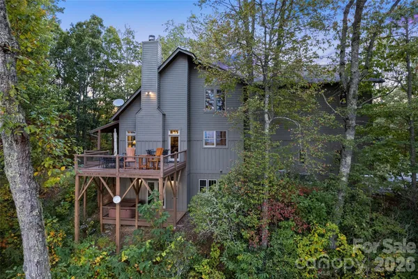 an aerial view of a house with roof deck and table