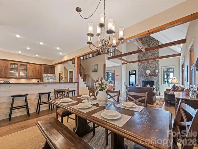 a view of a dining room with furniture wooden floor and chandelier