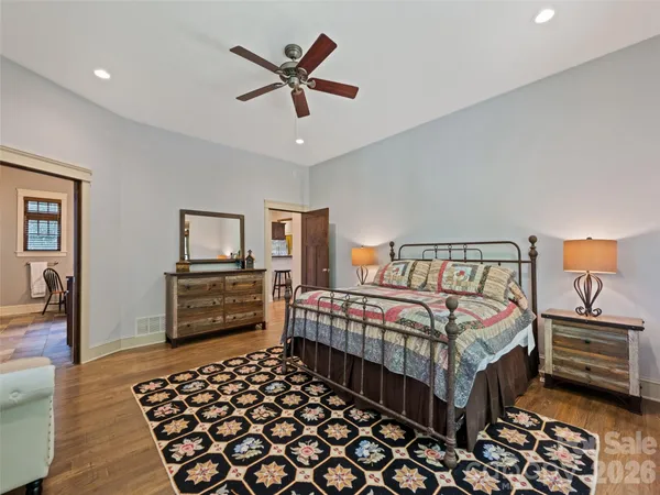 a bedroom with a bed and a chandelier
