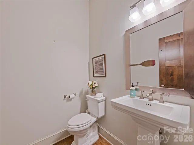 a bathroom with a sink a toilet and mirror