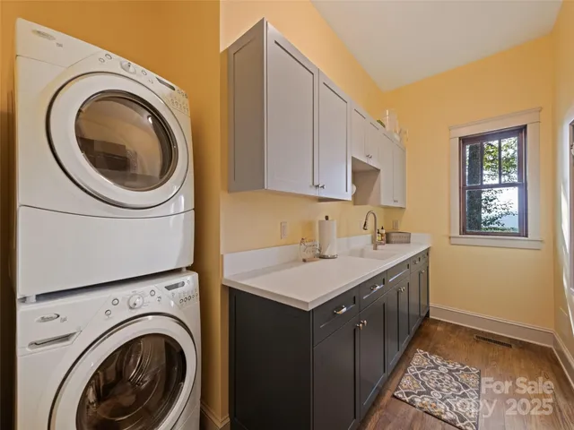 a utility room with sink dryer and washer