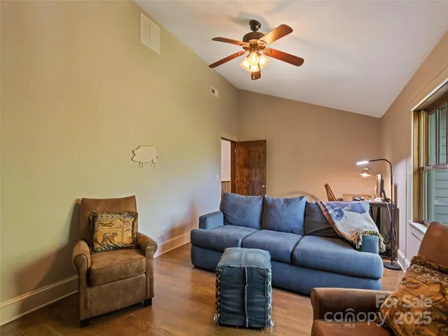 a living room with furniture a couch and a chandelier