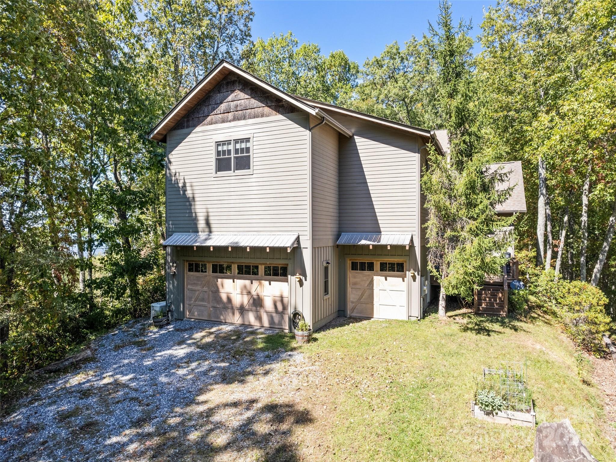 1635 Quest Ridge Sylva, NC 28779 - Photo 33 of 48 a front view of a house with a yard and garage