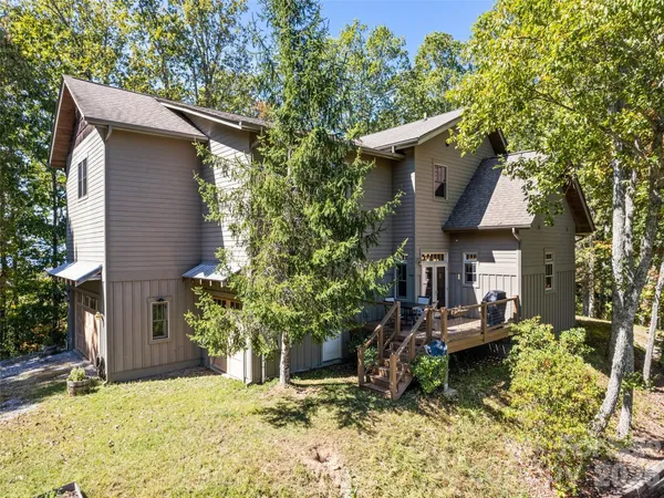 a view of a house with a yard and sitting area