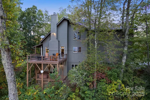 an aerial view of a house with roof deck and table