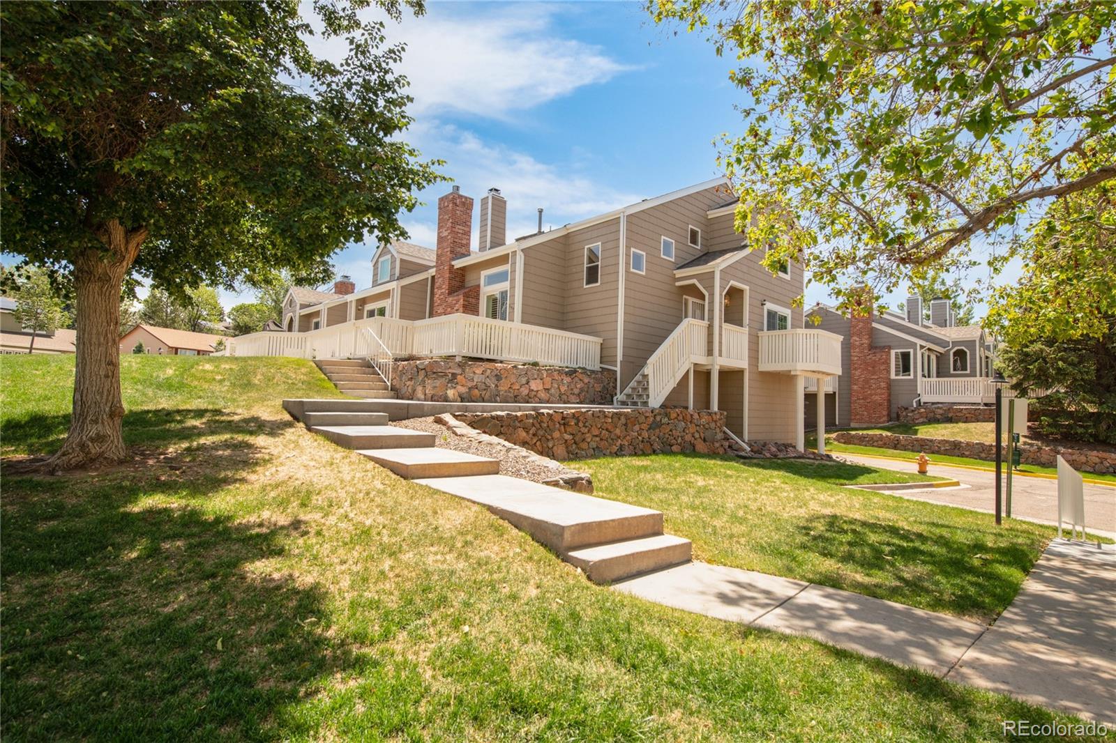 155 Blue Spruce Court Highlands Ranch, CO 80126 - Photo 2 of 29 a view of a house with swimming pool
