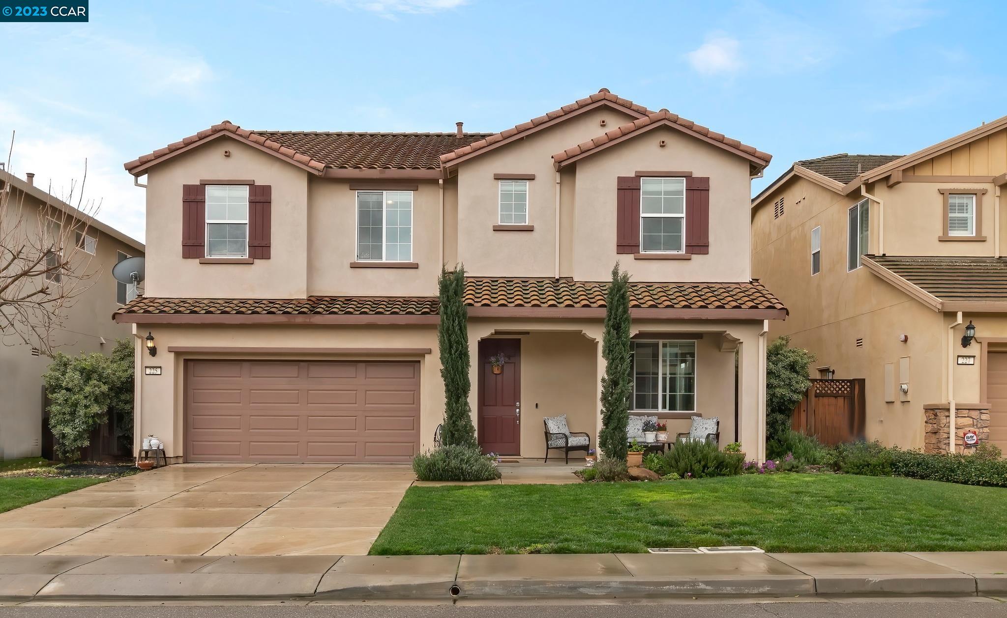 a front view of a house with a yard and garage