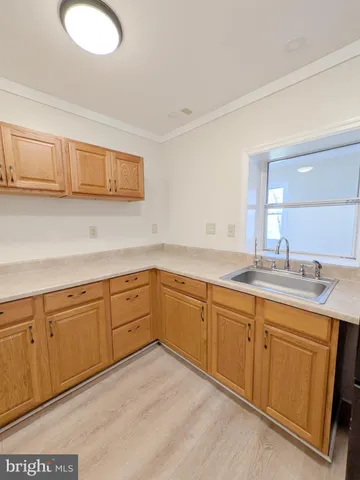 a kitchen with sink and cabinets