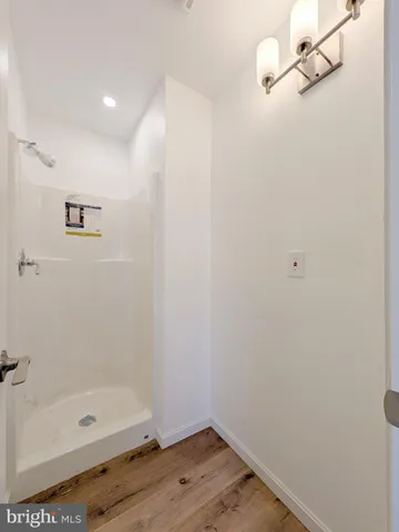 a bathroom with a glass shower door