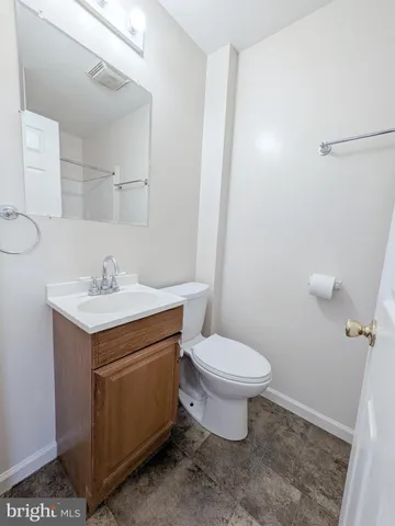 a bathroom with a sink toilet and vanity