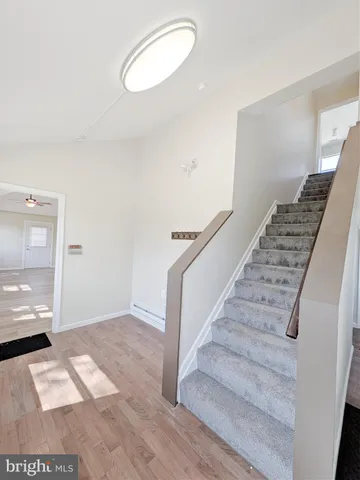 a view of entryway and hall with wooden floor