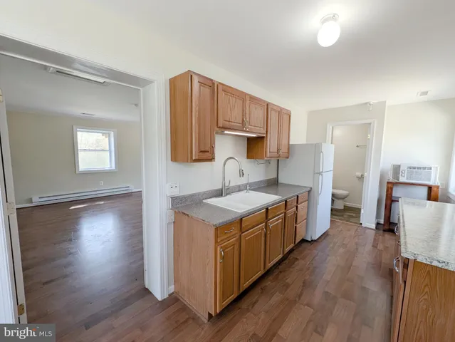 a kitchen with a stove a sink and a refrigerator