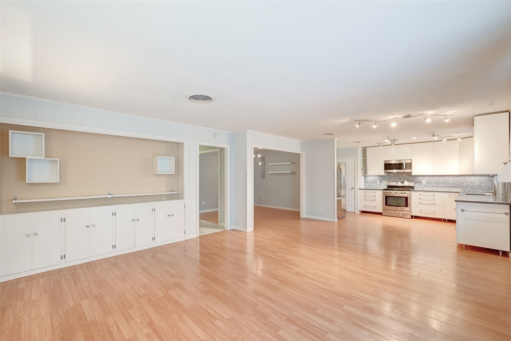 7335 Osage Street Houston, TX 77036 - Photo 3 of 12 a view of a kitchen with wooden floor and a sink