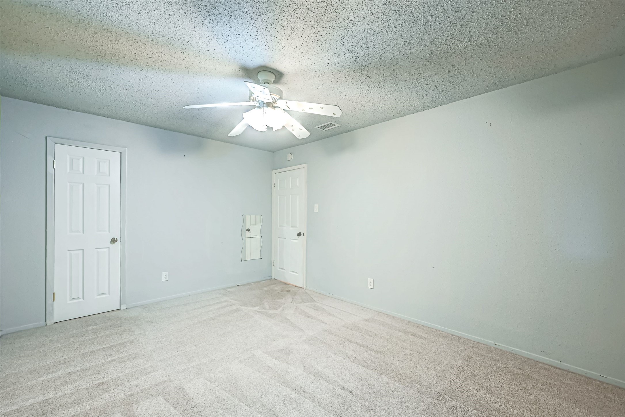 7335 Osage Street Houston, TX 77036 - Photo 10 of 12 a view of an empty room with a chandelier fan
