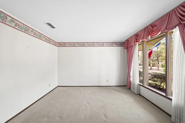 a view of empty room with fireplace