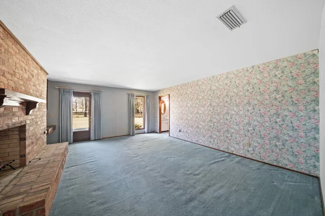 a view of an empty room with a fireplace