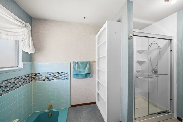 a view of an empty room with a chandelier fan