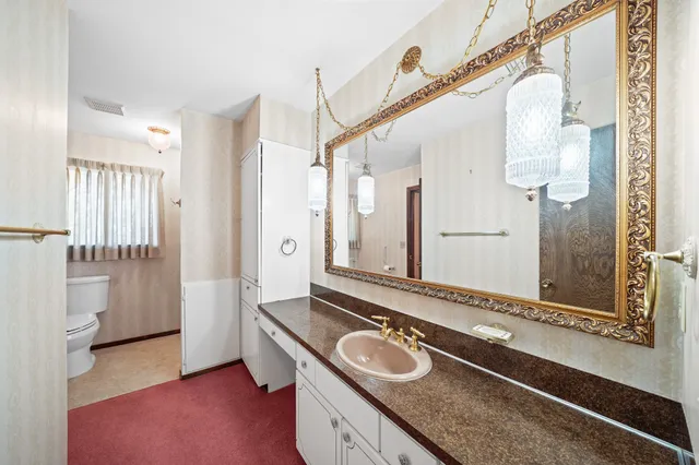 an empty room with fan and windows