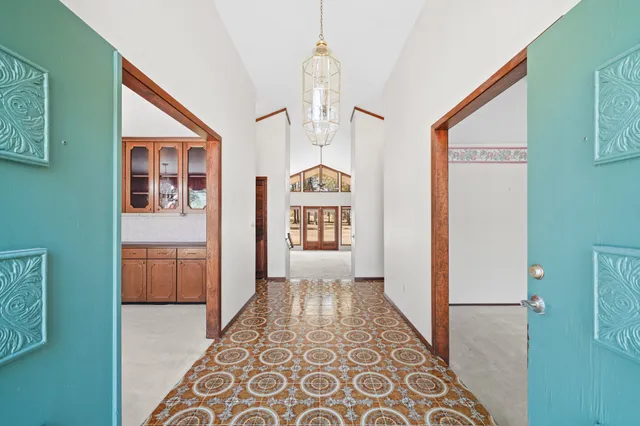 a view of a hallway with wooden floor and cabinet