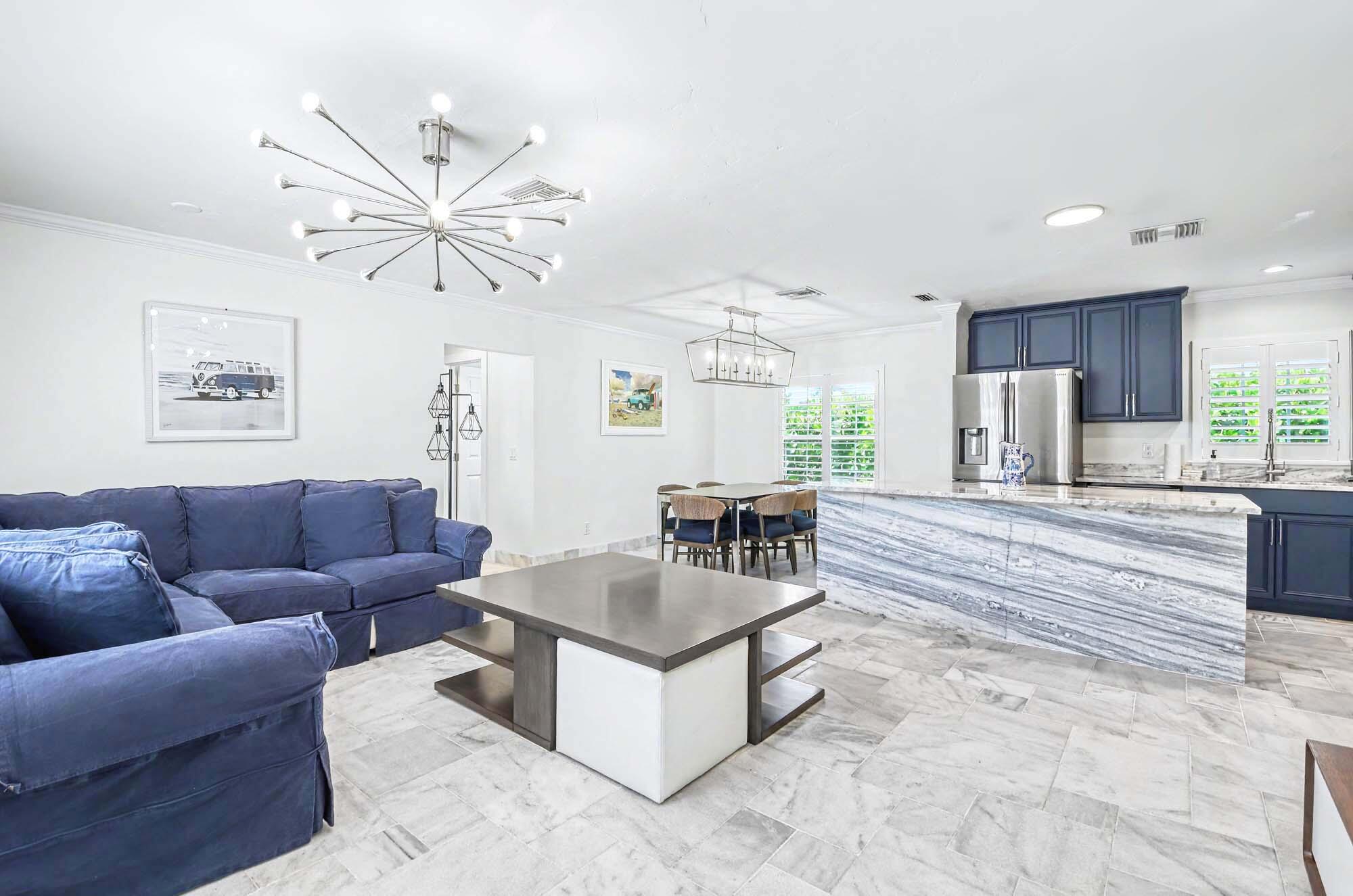 112 Capri Boulevard Naples, FL 34113 - Photo 5 of 29 a living room with furniture and a large window
