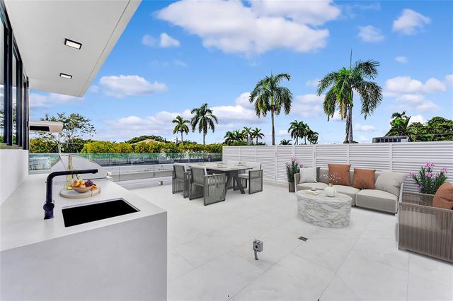 a kitchen with appliances cabinets and a large window