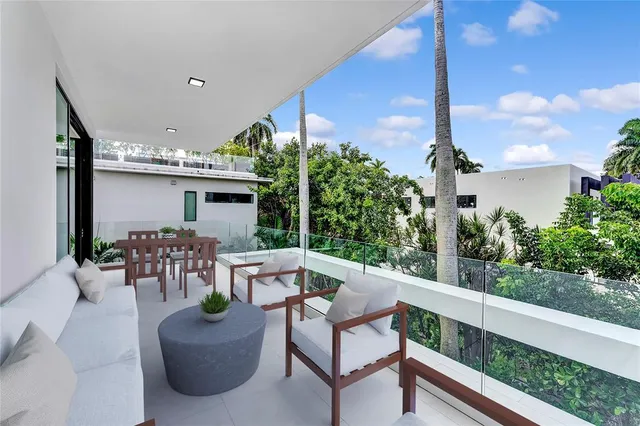a living room with furniture a lamp and a large window