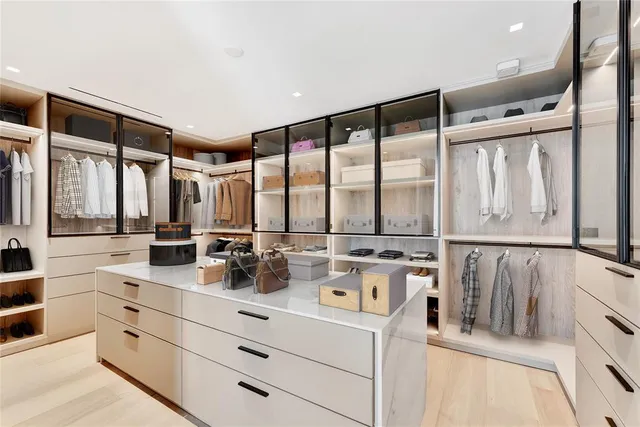 a bedroom with a large bed and a large window