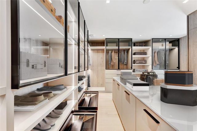 a living room with furniture large windows and flat screen tv