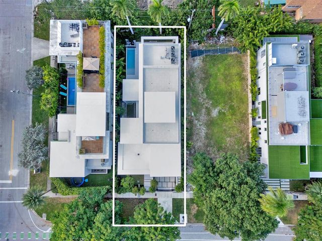 a view of a patio with table and chairs potted plants and large tree