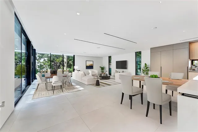 a kitchen with stainless steel appliances kitchen island granite countertop a sink and white cabinets