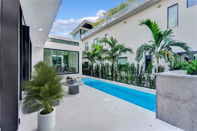 a view of a house with a yard and sitting area