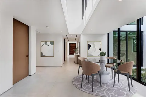 a view of a building with a window and potted plants