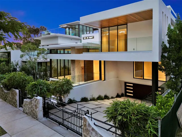 a view of a hallway with wooden floor and stairs