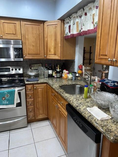 Kendall Green Pompano Beach, FL 33060 - Photo 13 of 24 a kitchen with stainless steel appliances granite countertop a sink stove and cabinets
