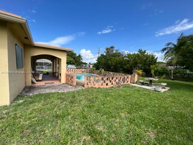 Kendall Green Pompano Beach, FL 33060 - Photo 18 of 24 a view of a garden with a bench