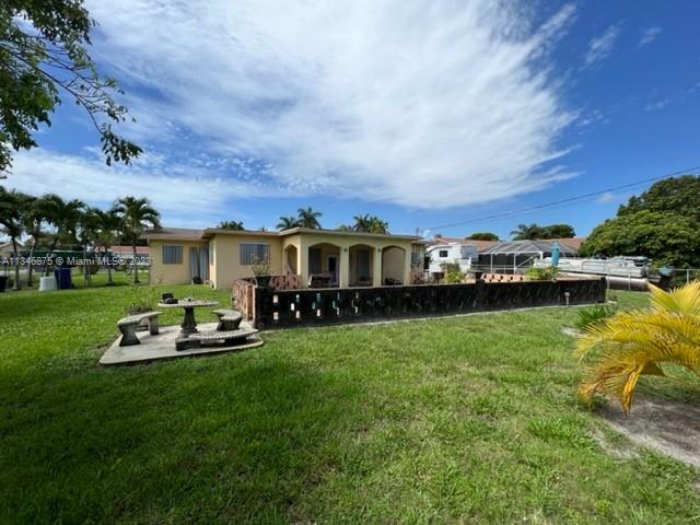 Kendall Green Pompano Beach, FL 33060 - Photo 20 of 24 a front view of a house with swimming pool garden and trees