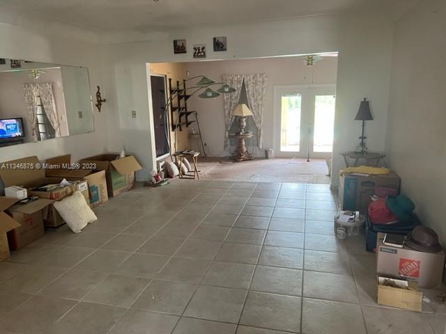 Kendall Green Pompano Beach, FL 33060 - Photo 3 of 24 a room with gym equipment and a mirror