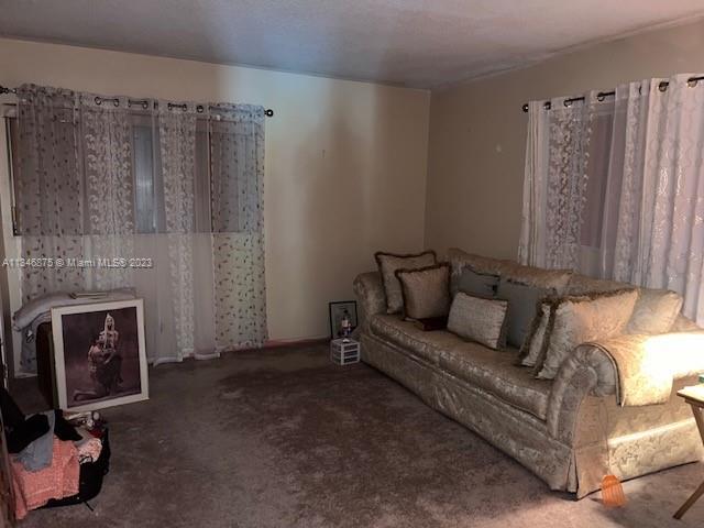 Kendall Green Pompano Beach, FL 33060 - Photo 4 of 24 a living room with furniture and a fireplace