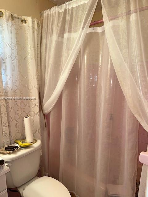 Kendall Green Pompano Beach, FL 33060 - Photo 5 of 24 a white toilet sitting next to a small sink