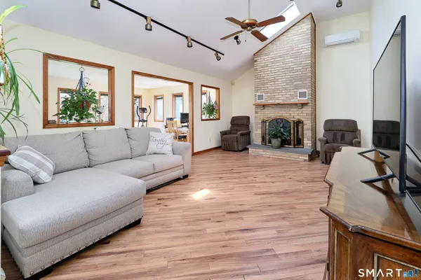 a living room with furniture fireplace and flat screen tv