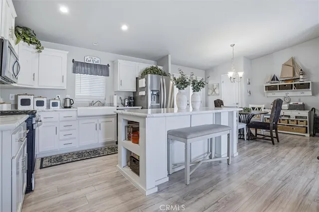 a kitchen with white cabinets and refrigerator