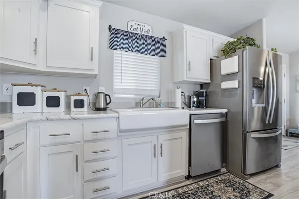 a kitchen with cabinets and wooden floor