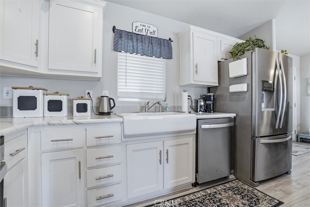500 Atascadero Road Morro Bay, CA 93442 - Photo 15 of 37 a kitchen with white cabinets and refrigerator